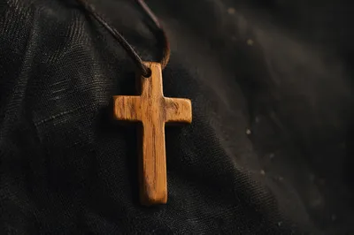 Minimalist Wooden Cross Pendant on Charcoal