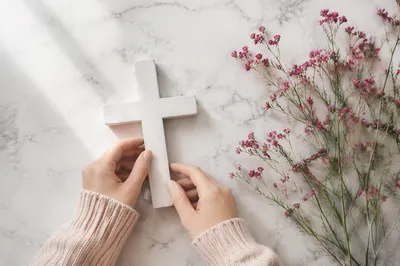 Minimalist White Cross with Magenta Wildflowers