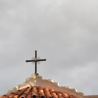 Minimalist Metal Cross on Terracotta Roof