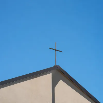 Minimal Cross on Beige Church Roof