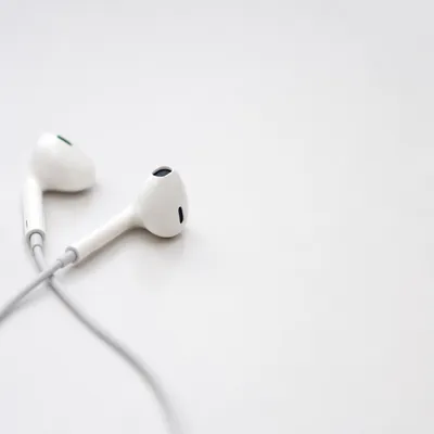 Minimal Earbud Cross on White Background