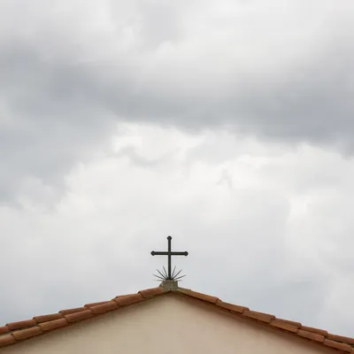 Minimalist Cross on Terracotta Roof