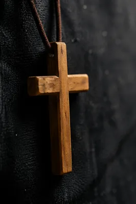 Minimalist Wooden Cross on Charcoal Fabric