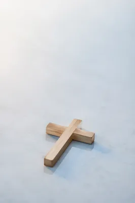Minimal Wooden Cross on Serene Blue Background