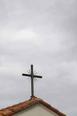 Minimalist Cross on Terracotta Roof