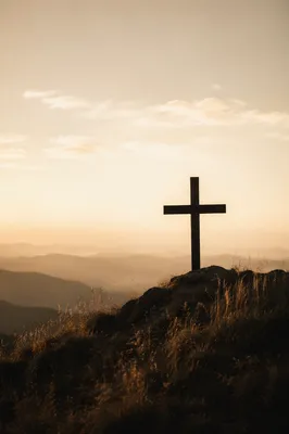 Minimal Wooden Cross on Dawn Hillside