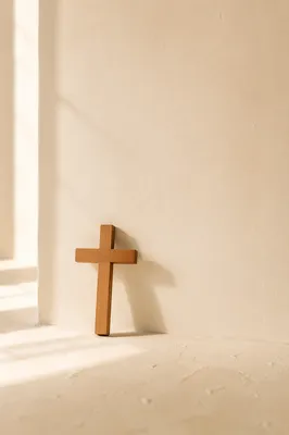 Minimal Wooden Cross on Cream Background