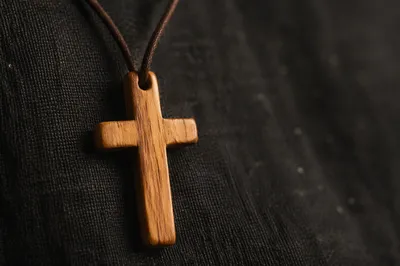 Minimalist Wooden Cross on Charcoal Fabric