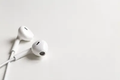 Minimal Earbud Cross on White Background