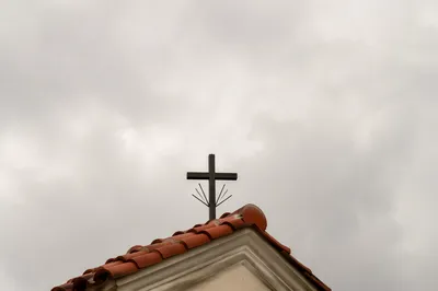 Minimalist Cross on Terracotta Roof