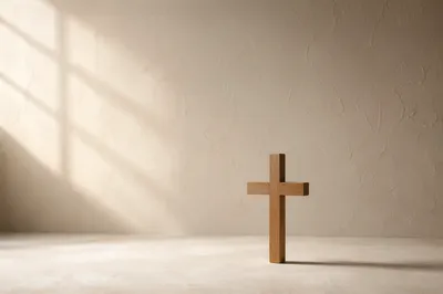 Minimalist Wooden Cross on Warm Plaster