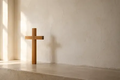 Minimal Wooden Cross on Warm Plaster