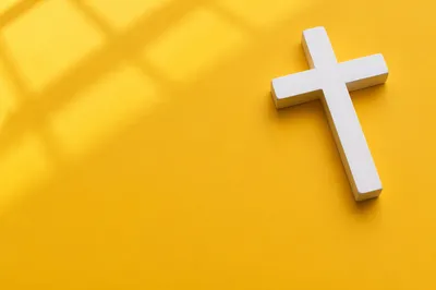 Minimalist White Cross on Golden Background