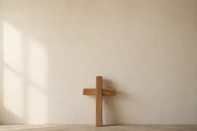 Simple Wooden Cross on Warm Wall