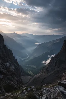 Misty Alpine Valley with Dawn Light Rays