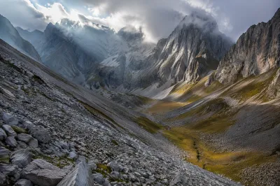 Misty Alpine Valley with Dawn Light Rays