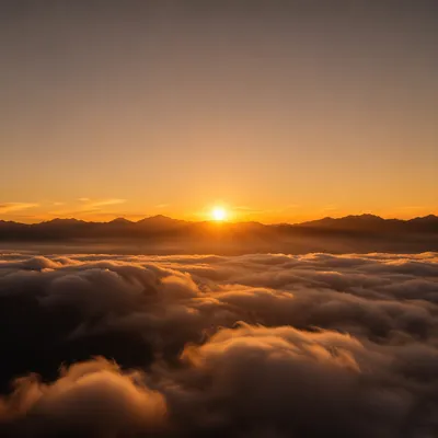 Sunrise Above Rolling Mountain Clouds