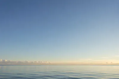 Calm Ocean Horizon Under Blue Sky