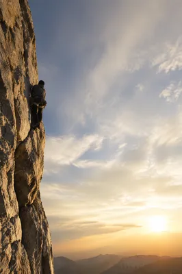 Lone Climber Rising in Hopeful Sky