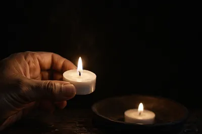 Hand Holding Tea Light Candle