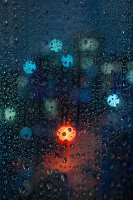 Rainy Night Window with Blurred City Lights