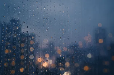 Rain Drops on Window with City Bokeh