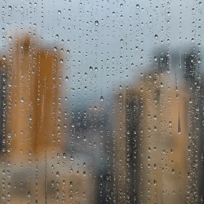 Rain Drops on Blurred City Window