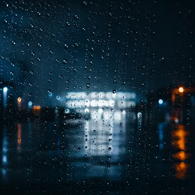 Rainy Night Window with Blurred City Lights