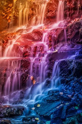 Rainbow Gradient Waterfall Over Autumn Stones