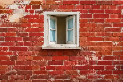 Vibrant Red Brick Wall with White Window