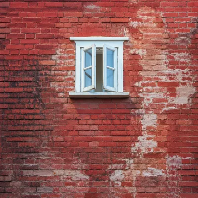 Vibrant Red Brick Wall With White Window