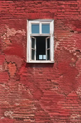 Vibrant Red Brick Wall With White Window
