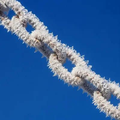 Frosted Chain Against Cobalt Winter Sky