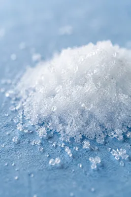 Loose White Snow Crystals on Blue Surface