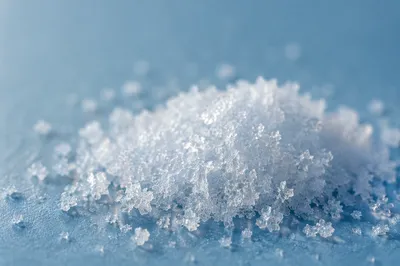 Macro Snow Crystals on Blue Surface