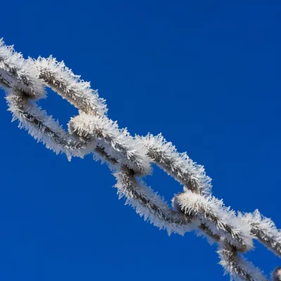 Frosted Chain Against Deep Winter Sky
