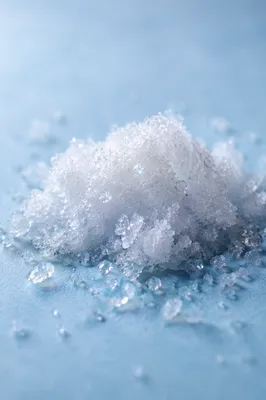 Macro White Snow Crystals on Blue Surface