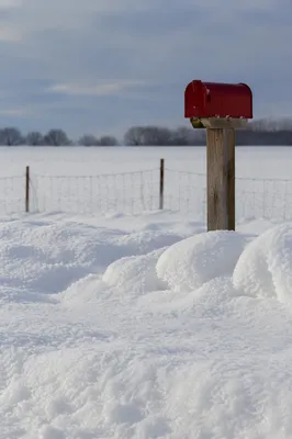 Red Rural Mailbox in Snowy Winter Field