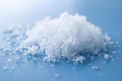 Macro White Snow Crystals on Blue Surface
