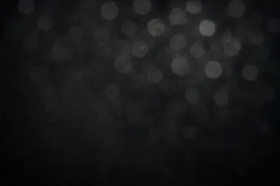 Soft Silver Bokeh on Dark Background