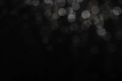 Soft Silver Bokeh on Dark Background