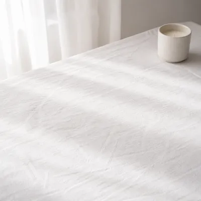 Clean White Linen Tabletop with Candle