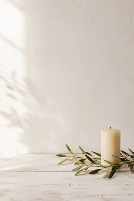 Minimal White Tabletop with Candle and Olive Branch