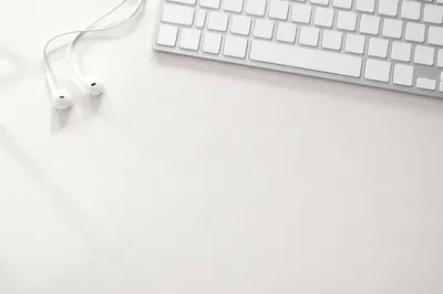 Minimal White Desk Background with Earbuds