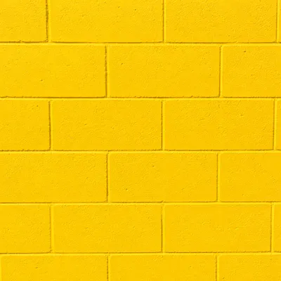 Bright Yellow Painted Block Wall Background