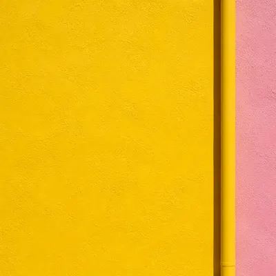 Bright Yellow Stucco Wall with Pink Accent