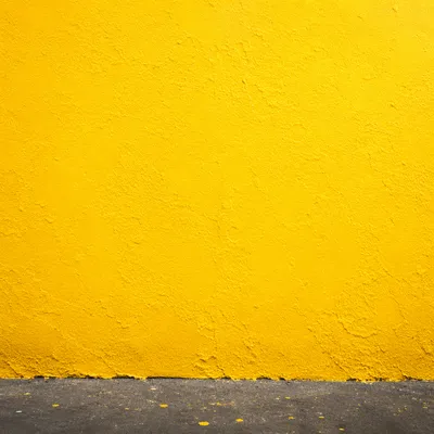 Bright Sunlit Yellow Stucco Background