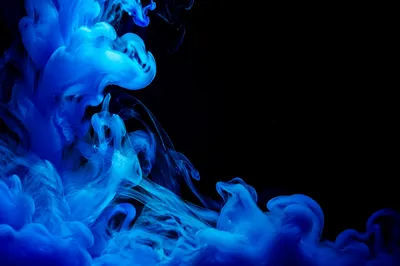 Blue Ink Swirls on Dark Background