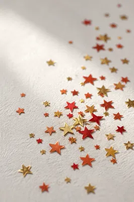 Festive Star Confetti on White Background