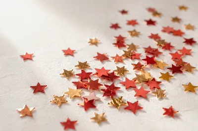 Festive Star Confetti on White Background